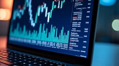 Close-up of a laptop displaying price trends and market data graphs.